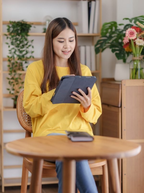 beautiful-asian-business-woman-working-at-home-using-digital-tablet-with-peace-of-mind-