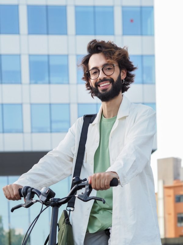 young-digital-entrepreneur-man-with-a-bike-in-a-financial-district-looking-at-camera